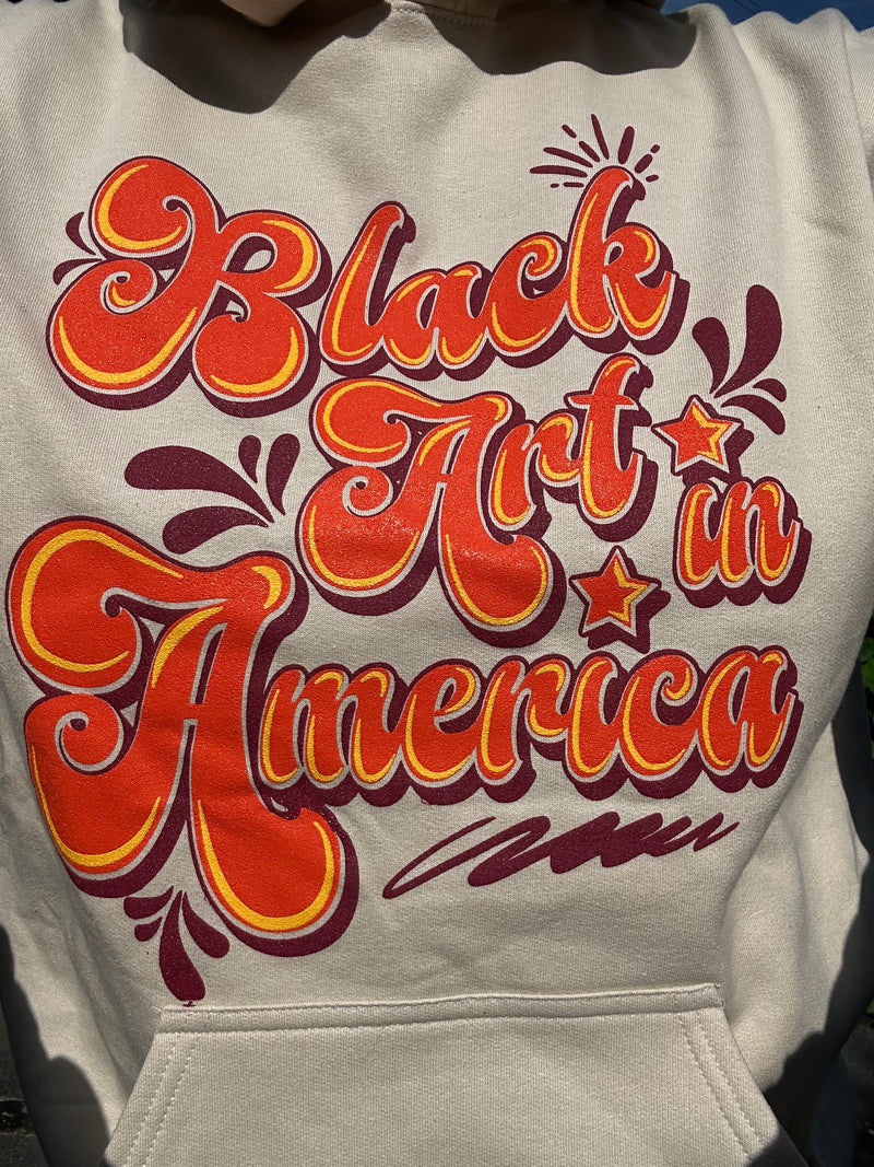 Black Art In America (Retro Sweatshirt) Tan w/orange letters