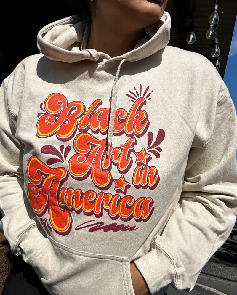 Black Art In America (Retro Sweatshirt) Tan w/orange letters