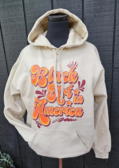 Black Art In America (Retro Sweatshirt) Tan w/orange letters